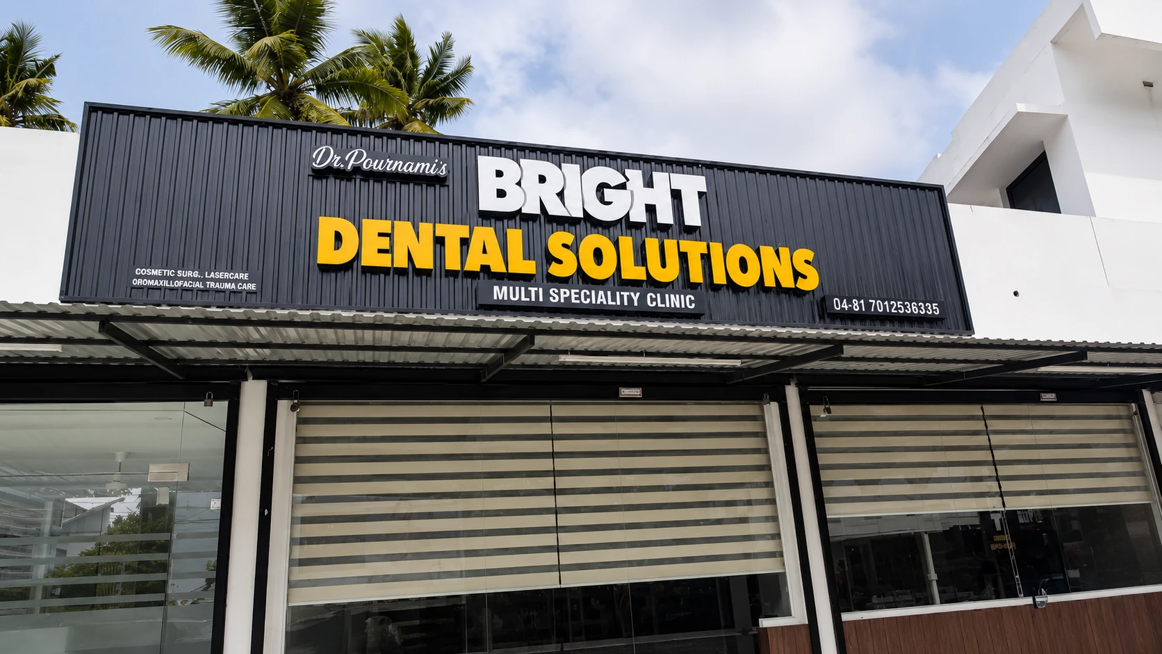 The Bright Dental Solutions shopfront at Kurakkanni, Varkala — a dark building with a yellow sign